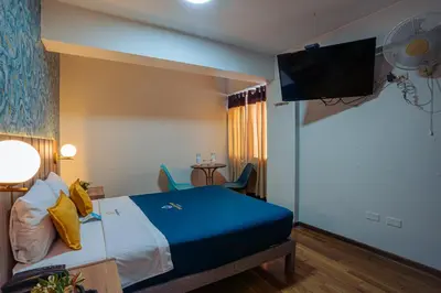 a hotel room with a bed and a flat screen tv at Golden Mar Hotel in Lima