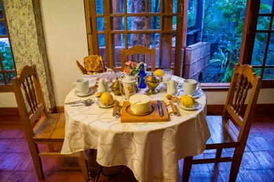 a dining room table with a white table cloth at Hotel Museo Casona Ugarte Leon in Concepción