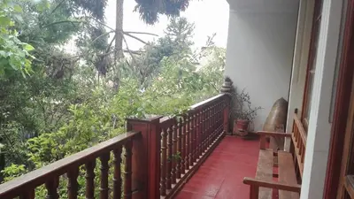 a balcony of a house with a view of trees at Hotel Museo Casona Ugarte Leon in Concepción
