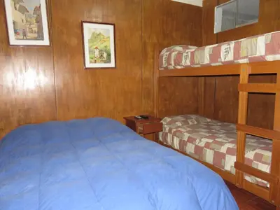 a bedroom with a bed and bunk beds on a boat at Hospedaje Del Pilar en Magdalena del Mar in Lima