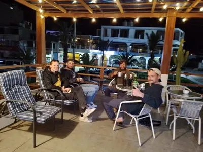 a group of people sitting at tables on a patio at El Capricho Paracas in Paracas