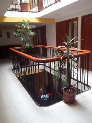 a balcony with two potted plants on it at Tierra del Inka in Cusco