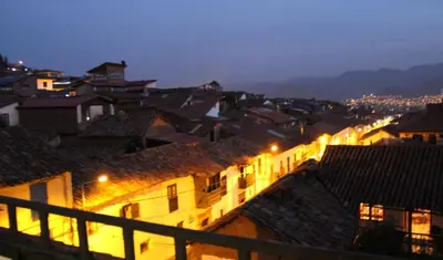 a view of a city at night with buildings at Tierra del Inka in Cusco