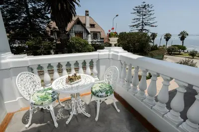 a white balcony with a table and chairs on it at Villa Barranco by Ananay Hotels in Lima