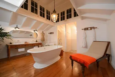 a bathroom with a large white tub and a sink at Villa Barranco by Ananay Hotels in Lima