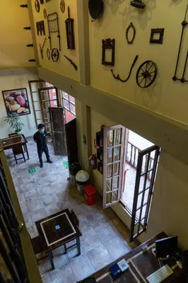 an overhead view of a living room with a man in a house at Desert Nights Hostel in Ica