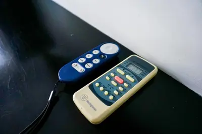 two remote controls sitting on top of a table at Apart Hotel Petit Palace Suites in Lima