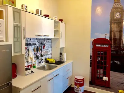 a kitchen with a sink and a red phone booth at Lindos Apartamentos en San Isidro in Lima