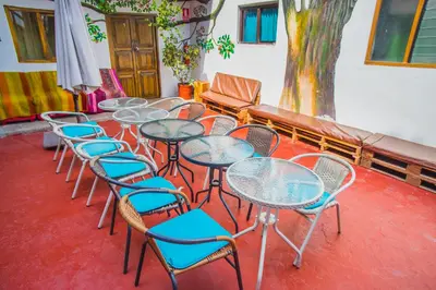 a row of tables and chairs in a room at Tucan Hostel in Cusco