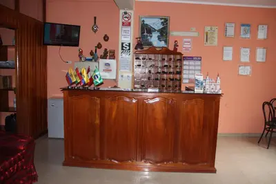 a large wooden counter in a room with aperature at Hotel Mi Casa in Ayacucho