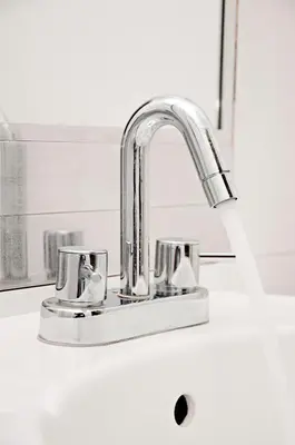a kitchen sink with a chrome kitchen faucet at Flamante Hotel & Suite in Lima