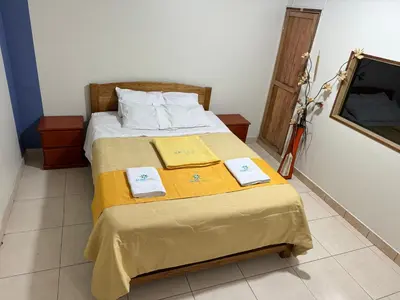 a bedroom with a bed with two towels on it at Illari Wari l - Hotel Sauna in Ayacucho
