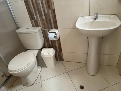 a bathroom with a toilet and a sink at Illari Wari l - Hotel Sauna in Ayacucho