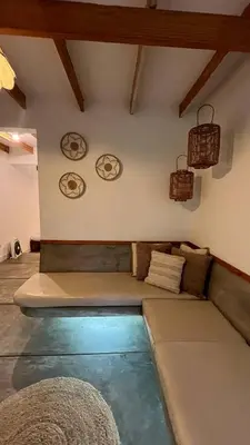 a living room with a couch and a pool at Villas de Cieneguilla in Cieneguilla