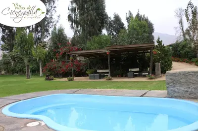 a swimming pool in a yard with a pavilion at Villas de Cieneguilla in Cieneguilla