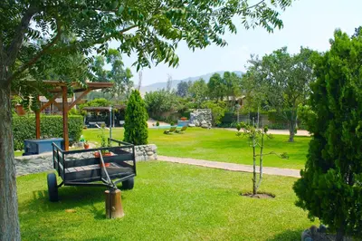 a park with a bench in the grass at Villas de Cieneguilla in Cieneguilla