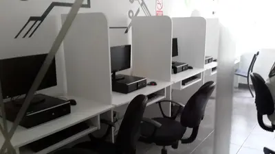 a room with a desk with two monitors and chairs at Lima Flats 3 in Lima
