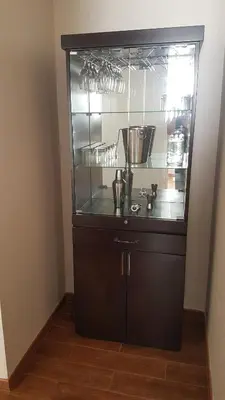 a kitchen with a glass cabinet with pots and pans at Lima Flats 3 in Lima