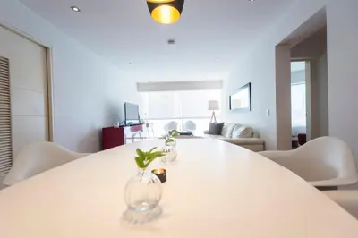 a white table with vases on it in a living room at InkaHuset Miraflores Deluxe in Lima