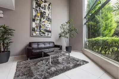 a living room with a leather couch and a table at InkaHuset Miraflores Deluxe in Lima