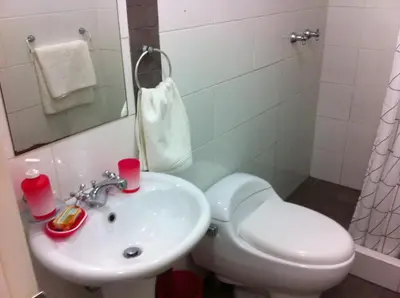 a bathroom with a toilet and a sink at Departamento Miraflores in Lima