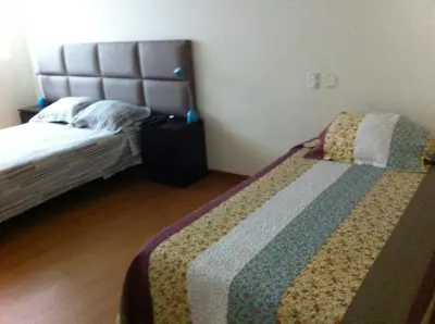 a room with two beds in a room at Departamento Miraflores in Lima
