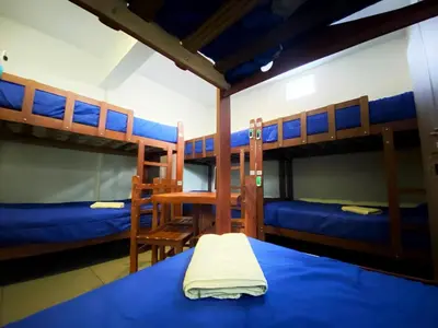 a bedroom with two bunk beds with blue sheets at Lima House Hostel in Lima