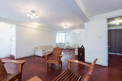 a living room with a couch and a table and chairs at InkaHuset Airport in Lima