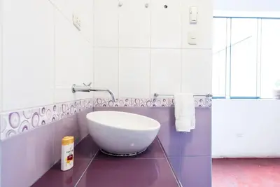 a bathroom with a large white bowl sink on a counter at InkaHuset Airport in Lima