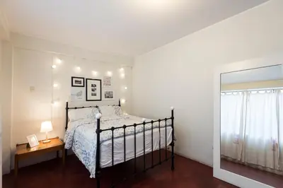 a bedroom with a bed and a mirror at InkaHuset Airport in Lima