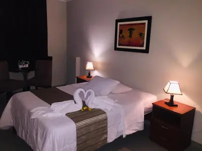 a hotel room with a bed with swans on it at PiscoMar Peru in Pisco
