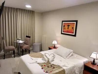 a hotel room with a bed with two towels at PiscoMar Peru in Pisco