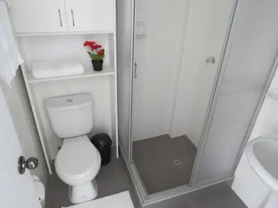 a bathroom with a toilet and a shower at Apartamentos Quewe in Cusco