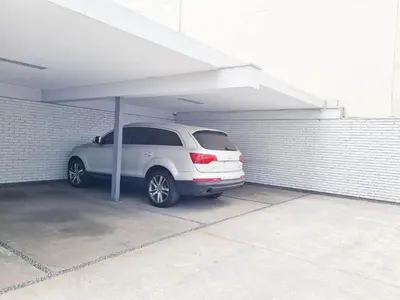 a white car parked under a parking garage at OceanFront Larcomar Apartments in Lima