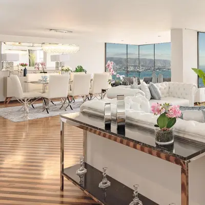 a living room with a white couch and a table at OceanFront Larcomar Apartments in Lima