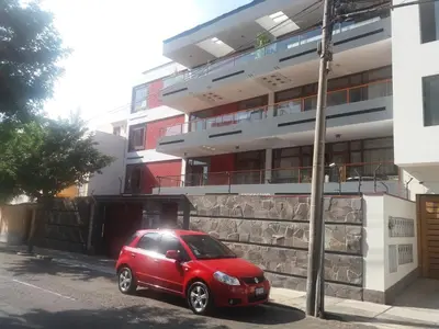 a red car parked in front of a building at Miraflores in Lima