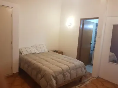 a small bedroom with a bed in a room at Family House in Lima