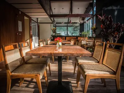 a wooden table and chairs in a room at Jaya Machu Picchu Boutique Hotel in Machu Picchu