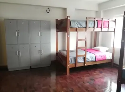 a bedroom with two bunk beds and white cabinets at Kelebek Hostel in Lima