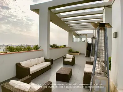a balcony with a couch and chairs on a building at ALU Apartments - Limit with Miraflores Panoramic City View in Lima