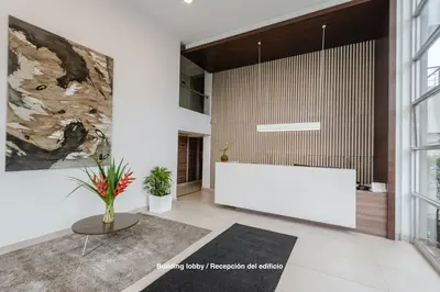 a lobby with a large white table in a room at ALU Apartments - Limit with Miraflores Panoramic City View in Lima