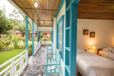 a bedroom with a bed on a porch at Cemayu Lodge in Oxapampa