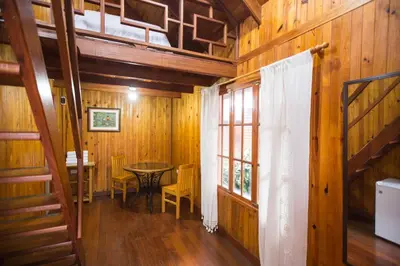 a dining room with a table and chairs in a cabin at Cemayu Lodge in Oxapampa