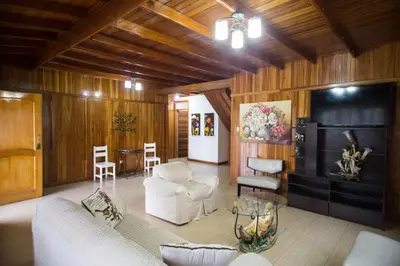a living room with a couch and chairs and a table at Cemayu Lodge in Oxapampa