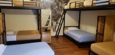 two bunk beds in a room with two beds at Hommam in Cusco