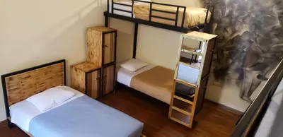 a room with two bunk beds and a ladder at Hommam in Cusco