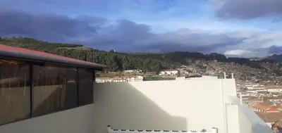 a view of a city from the roof of a building at Hostal Kuntur Cusco in Cusco