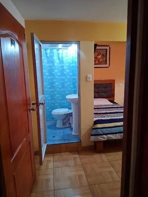 a bathroom with a toilet and a sink at Hostal Kuntur Cusco in Cusco