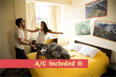 a man and woman standing in a hotel room at Pariwana Hostel Lima in Lima