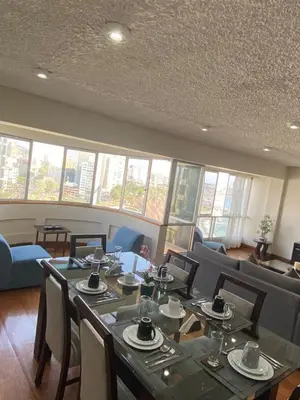 a dining room with tables and chairs and windows at Oceanfront Miraflores Larcomar next to Marriott in Lima